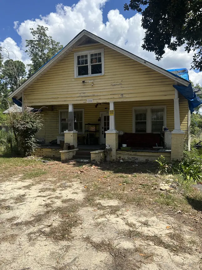 Worn CSRA rental house with roof tarp bought as-is by Sell My House Fast Augusta